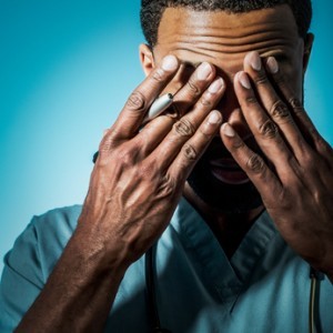 Exhausted African American Doctor Rubbing His Eyes