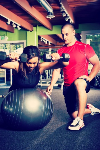 A Male Personal Trainer training his client