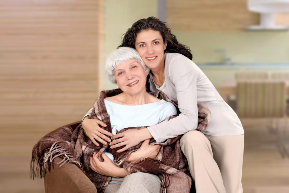 elderly woman and her daughter sitting in a chair with a blanket, hug, mother, grandmother